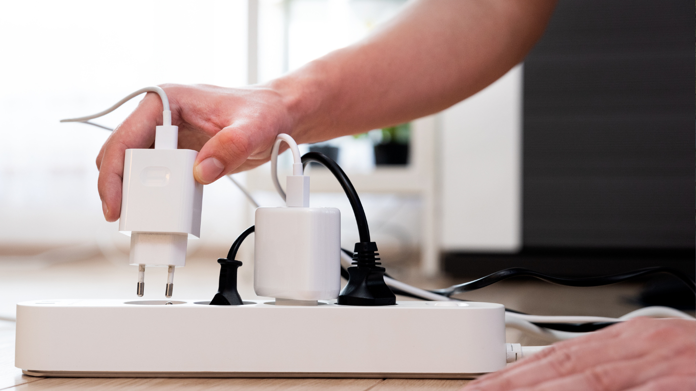 A person is plugging a device into a charger